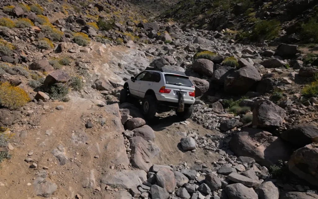 This heavily modified off-roader had once been just a regular BMW X5, the kind you’d expect to see doing school runs rather than climbing rocks.