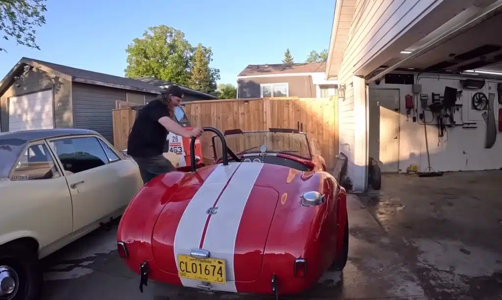 AC Cobra muscle car in a shipping container