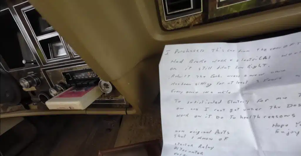 abandoned Lincoln Continental Mark V with a handwritten note