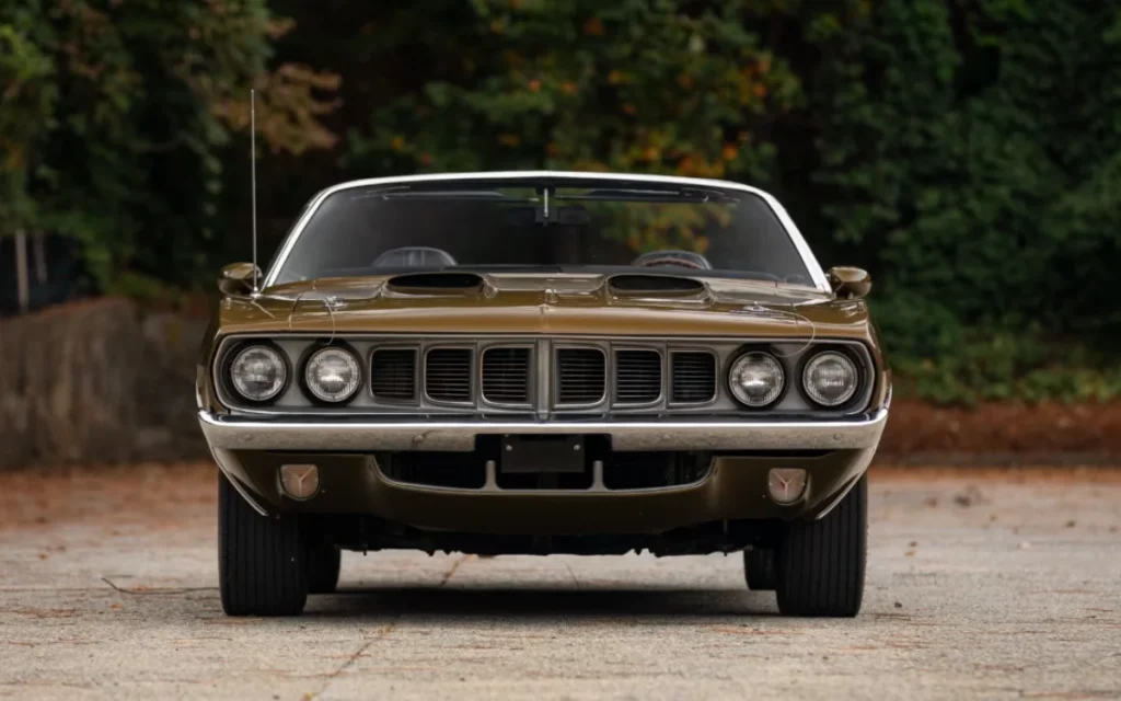This stunning Tawyn Gold 1971 Plymouth Cuda had a famous former owner who left their mark by signing their autograph in silver on the sun visor