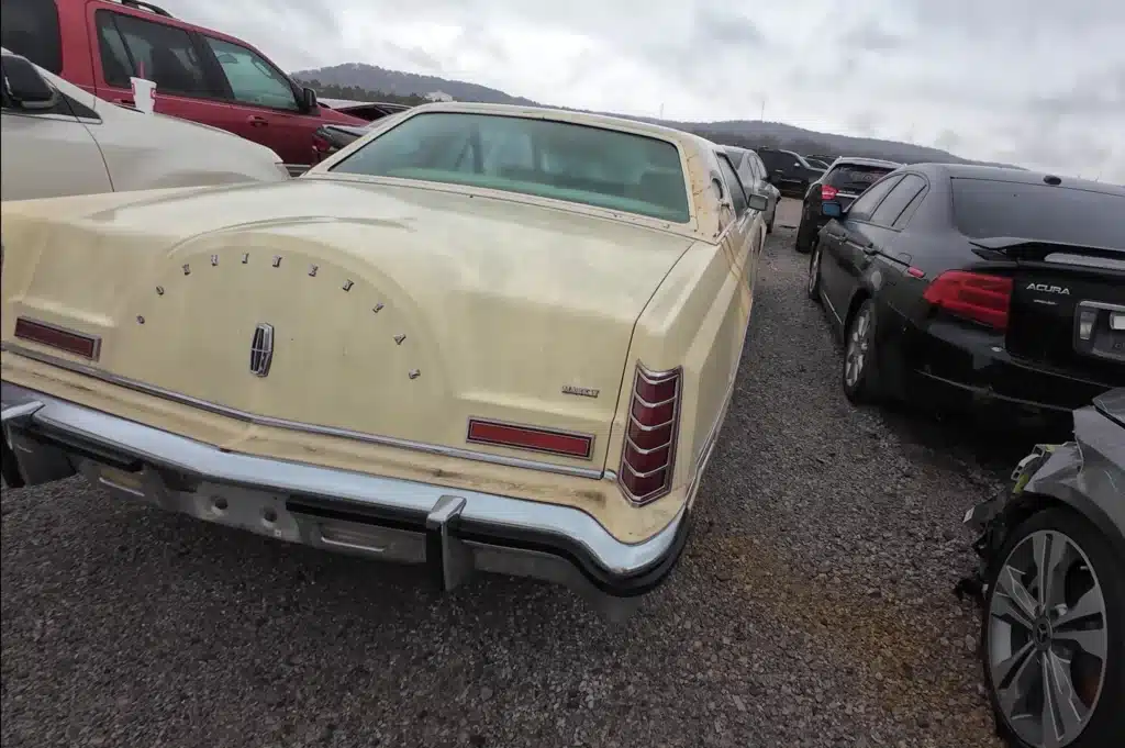 abandoned Lincoln Continental Mark V with a handwritten note