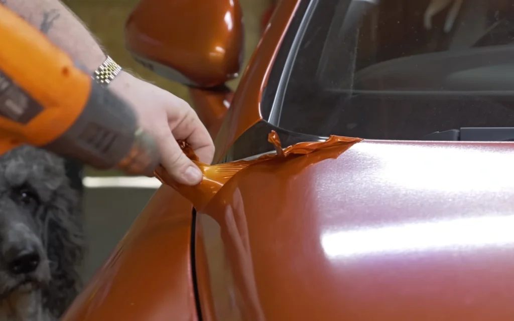 A YouTuber decided to peel the bright orange wrap off his cheap Bentley Continental GT and see what secrets the luxury coupe had been hiding for years. 