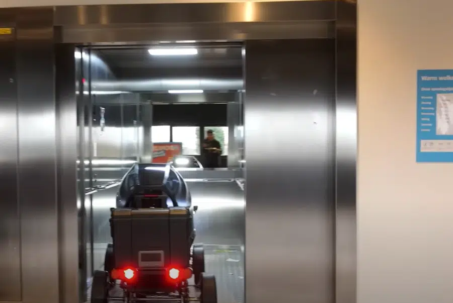 The world's smallest electric car fitting into an elevator.