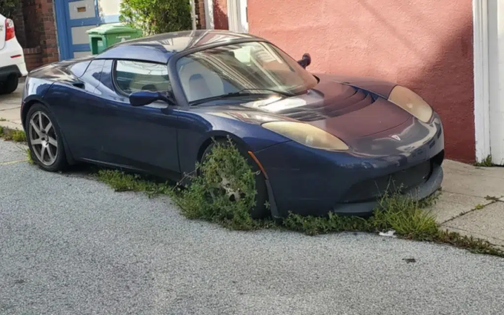 Man found rare Tesla Roadster abandoned on a San Francisco street with weeds growing out of it