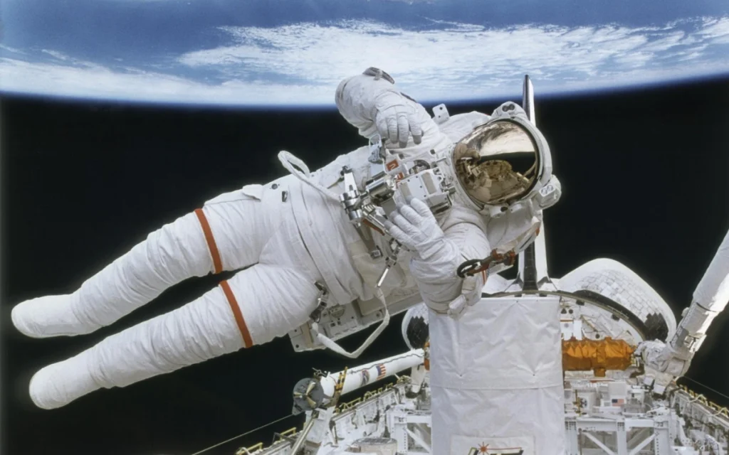 In one of the most iconic space photos of all time, astronaut Bruce McCandless II performs an untethered spacewalk that looks as unreal today as it did in 1984.