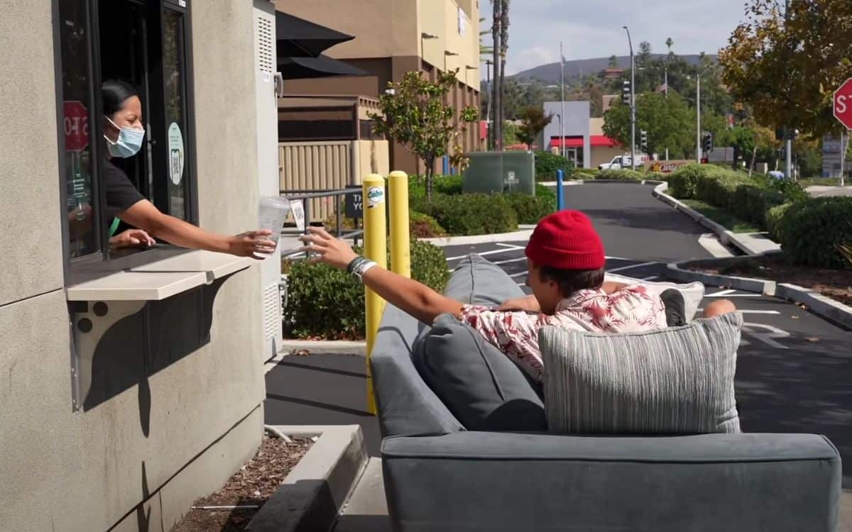 The content creator going through the drive thru with the drivable couch.