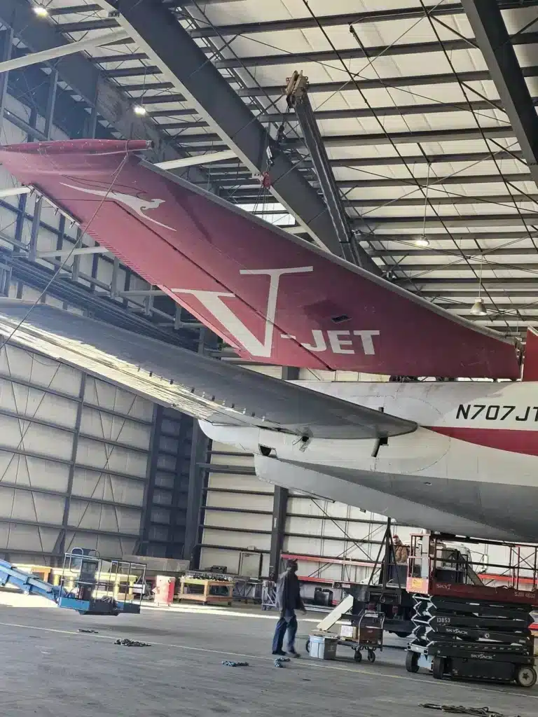 John Travolta's iconic Qantas Boeing 707 has been spotted lying in a parking lot with its tail rotting away.