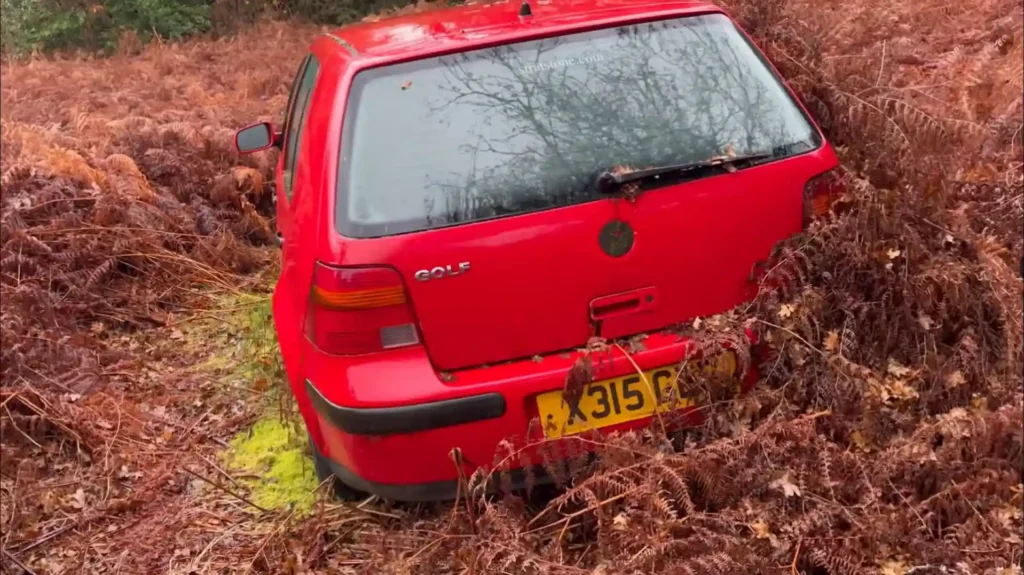 abandoned car graveyard uk forest