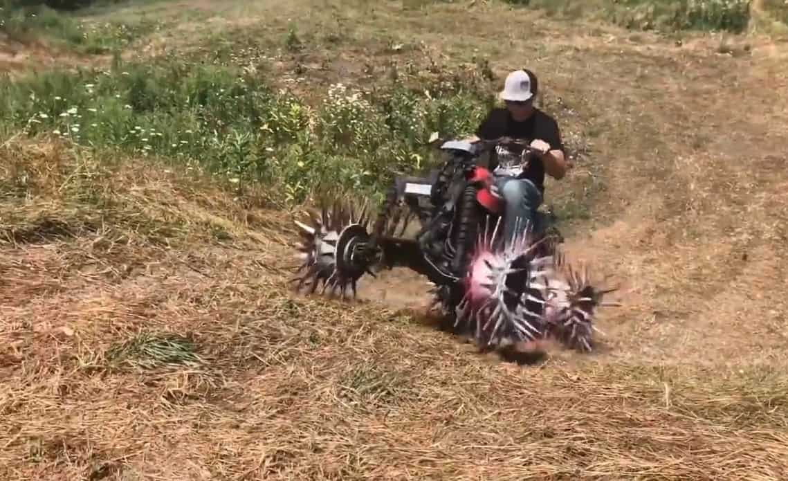 Cody from Whistlin Diesel riding the four-wheeler with reaper wheels 