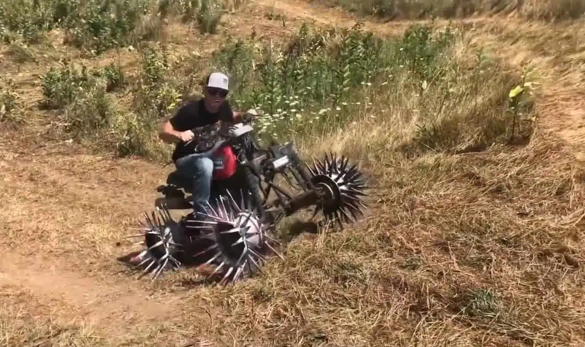 Cody from Whistlin Diesel riding the four-wheeler with reaper wheels 