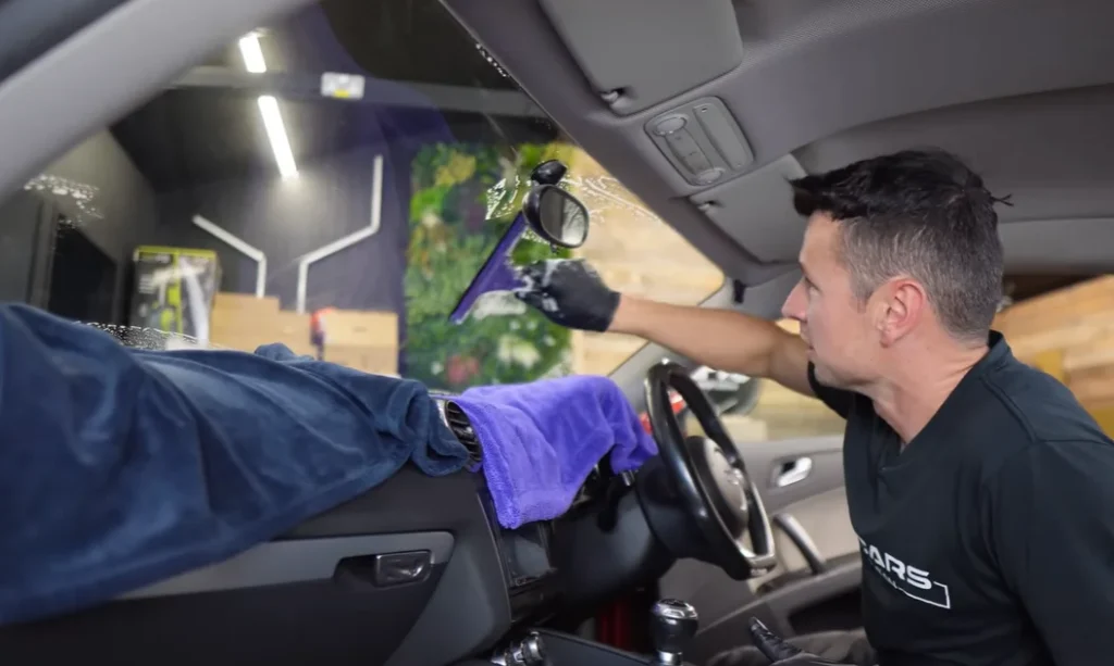 A pro detailer reveals the real cause of that stubborn interior windshield haze and the simple squeegee trick to clear it for good