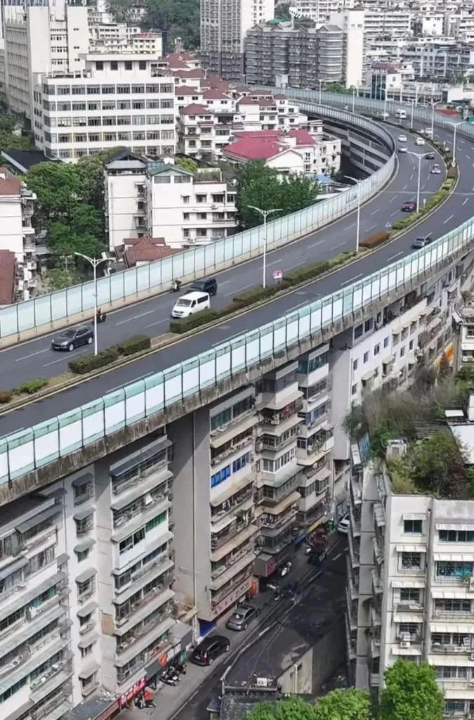 There's a block of apartments in China which was built directly underneath a highway